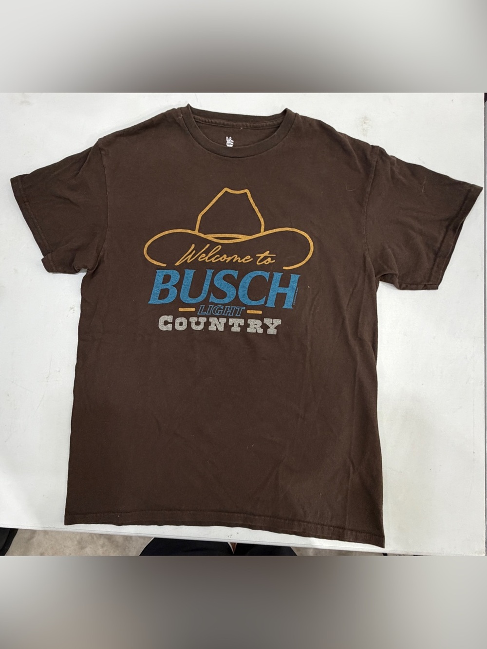 Junk Food Clothing Brown Tee with Blue and Gold Graphic